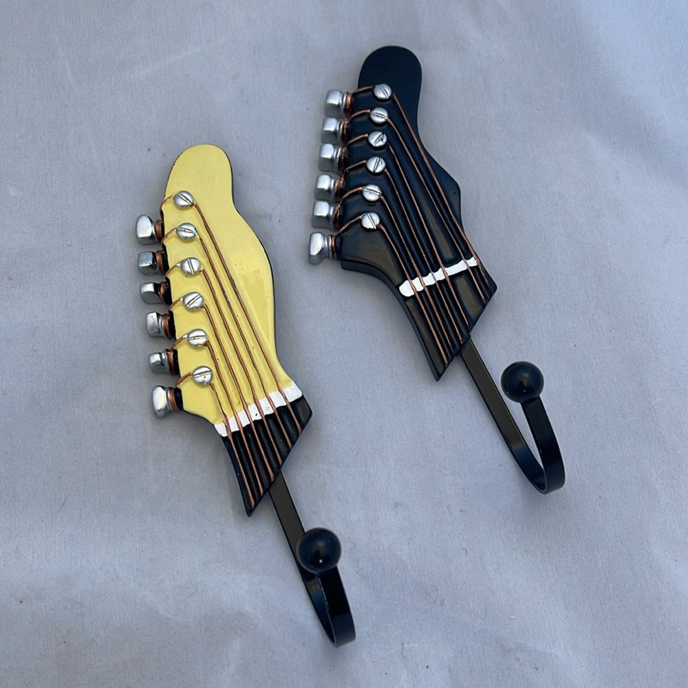 Two guitar wall hooks. Approx 7” long x 2.5” at its widest. Great for musicians!